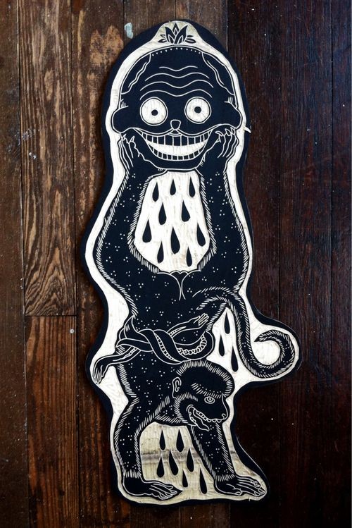 Black printed monkey keeping a head in legs tattoo design
