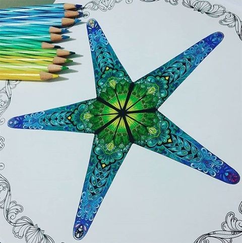 Blue ornate starfish with green center tattoo design
