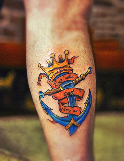 Bright blue anchor with golden crown on top tattoo on shin