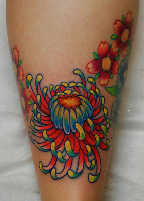 Bright colored japanese flower tattoo on shin