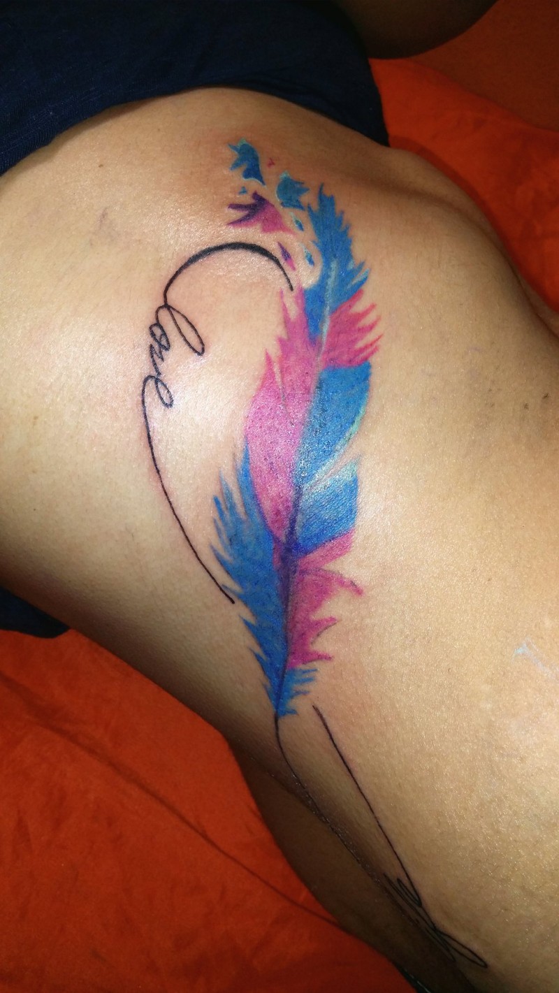 Bright colorful feather tattoo on rib-side