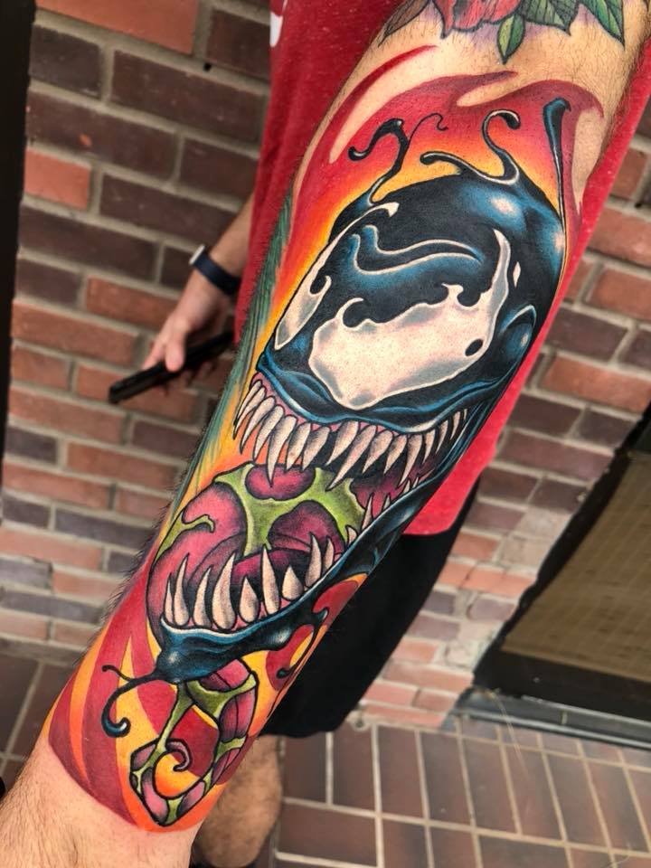 Bright venom tattoo on arm