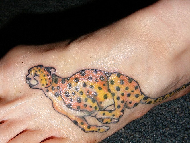 Cartoon colorful running cheetah tattoo on foot