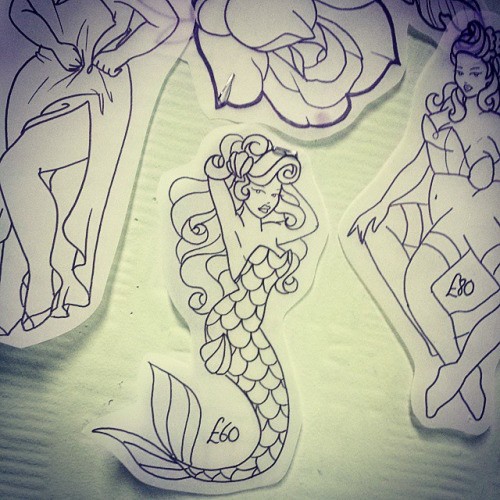 Chic colorless mermaid dressed in scale tattoo design