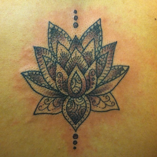Classic black tribal lotus flower tattoo on back
