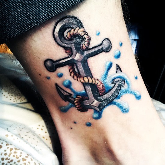Colored roped anchor in blue splashes tattoo for guys on ankle