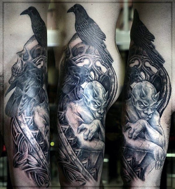 Colorful fantasy style large thigh tattoo of gargoyle combined with human skull and crow