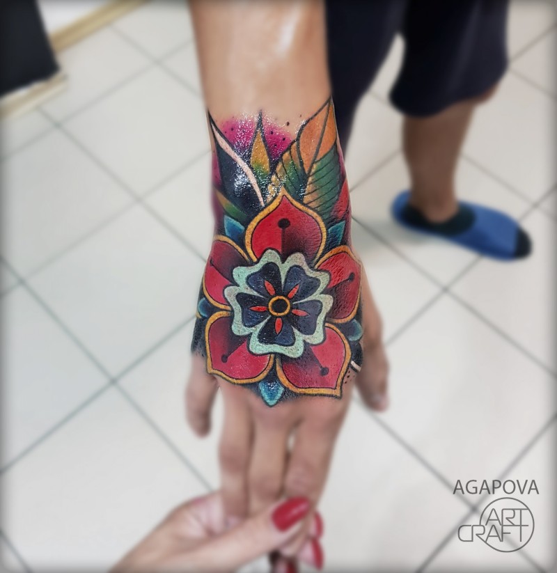 Colorful flower tattoo on wrist
