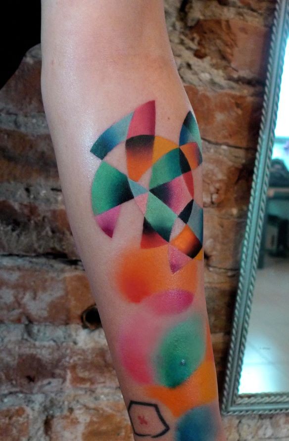 Colorful painted by Mariusz Trubisz forearm tattoo of geometrical ornaments