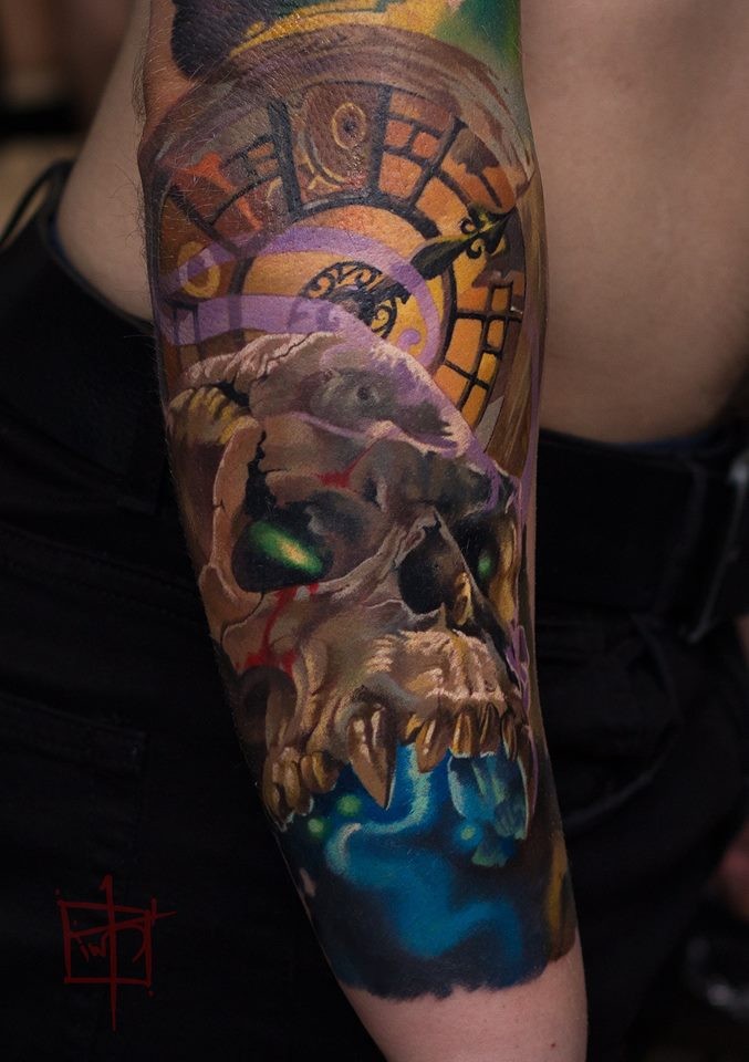 Colorfull skull and clock tattoo on arm
