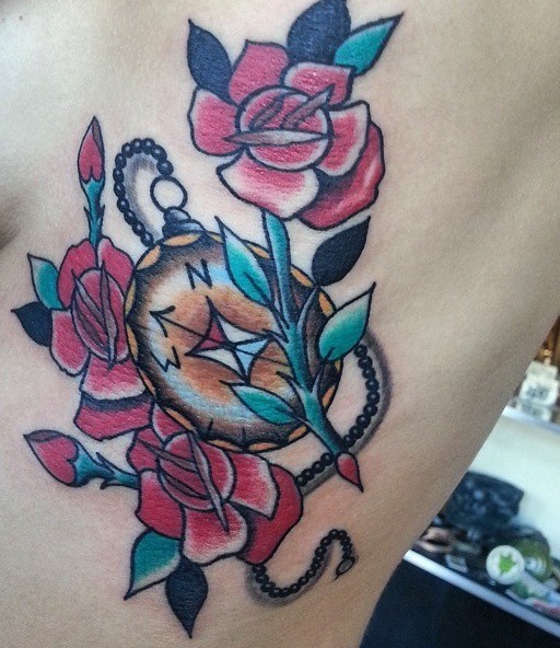 Colourful american classic tattoo with roses and compass on ribs