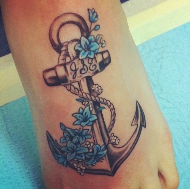 Cool black-and-white anchor with blue flowers tattoo on foot