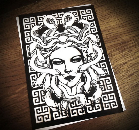 Cool black-and-white medusa gorgona face on geometric-patterned ackground tattoo design
