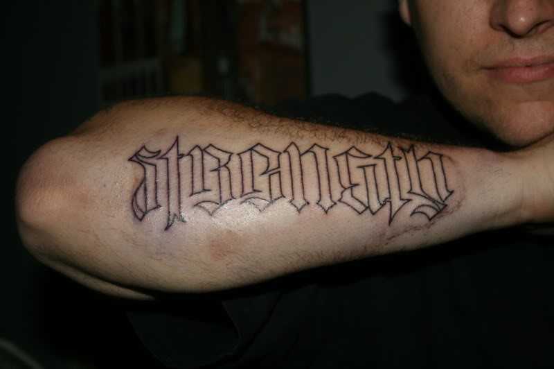 Cool black-contour strenght word tattoo on forearm