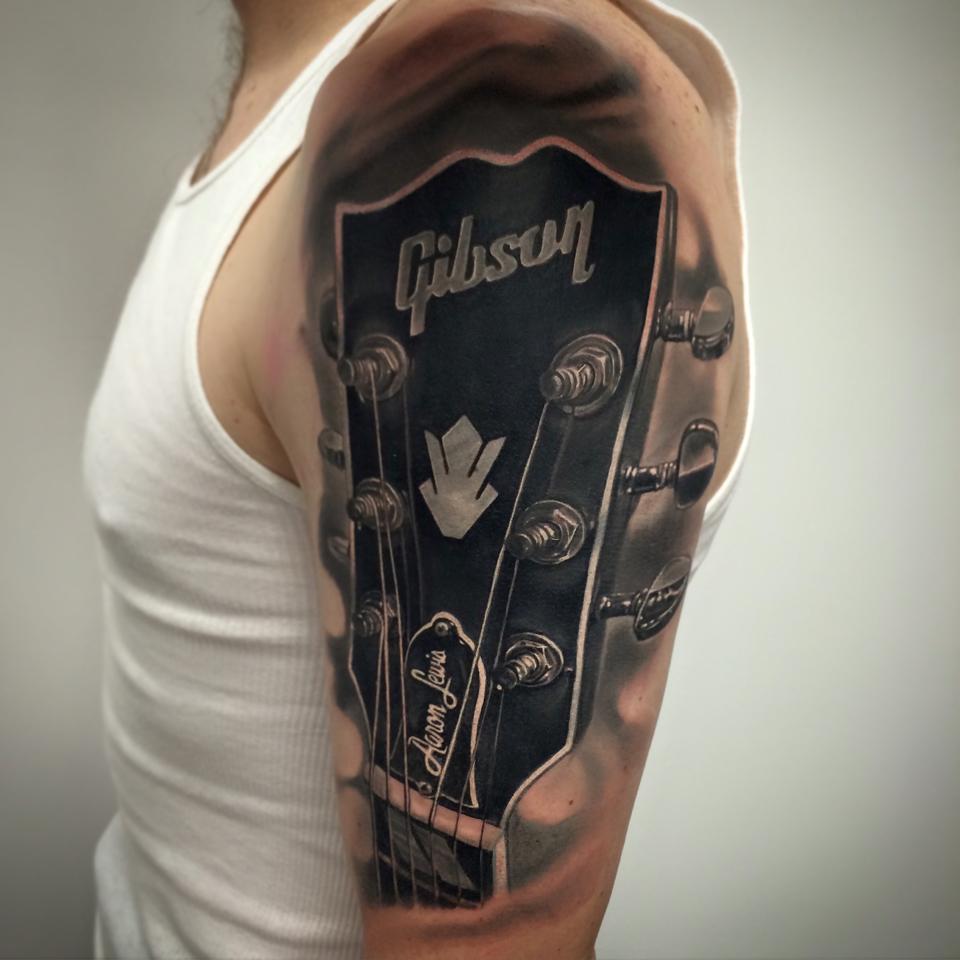 Cool gibson guitar tattoo on shoulder