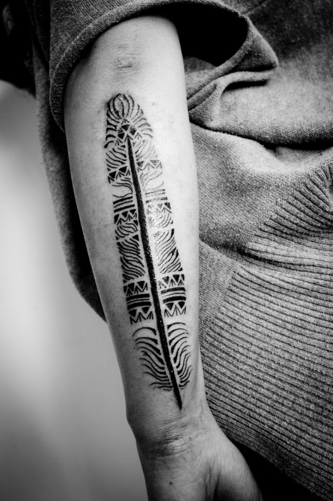 Cool long tribal feather tattoo on arm