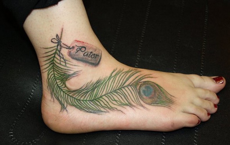 Cool lush green peacock feather tattoo on foot