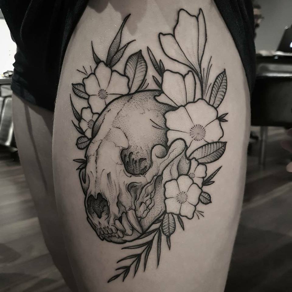 Cool skull and flowers tattoo on thight