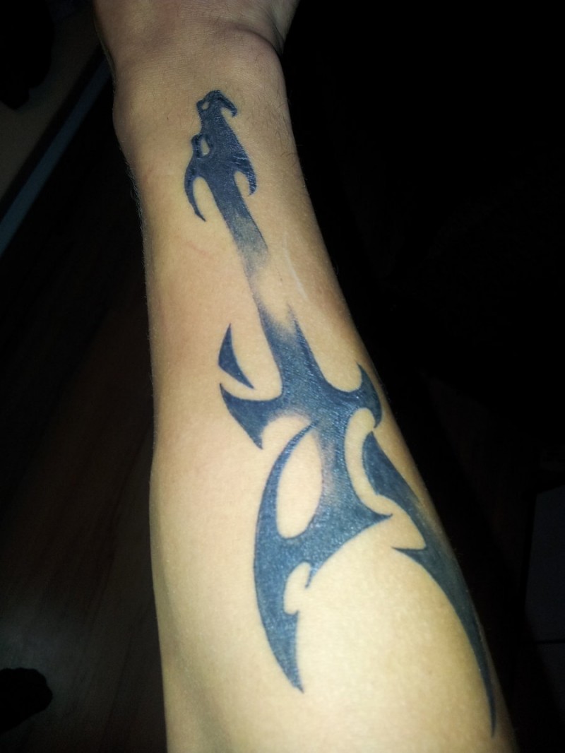 Cool tribal black guitar tattoo on forearm