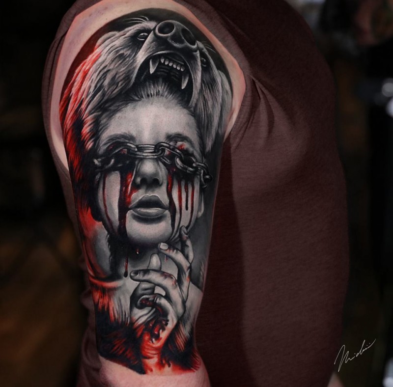 Cool woman face with bloody eyes tattoo on shoulder