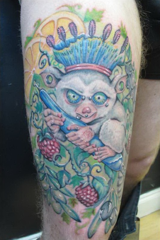 Crazy twisted lemur in cown tattoo on thigh