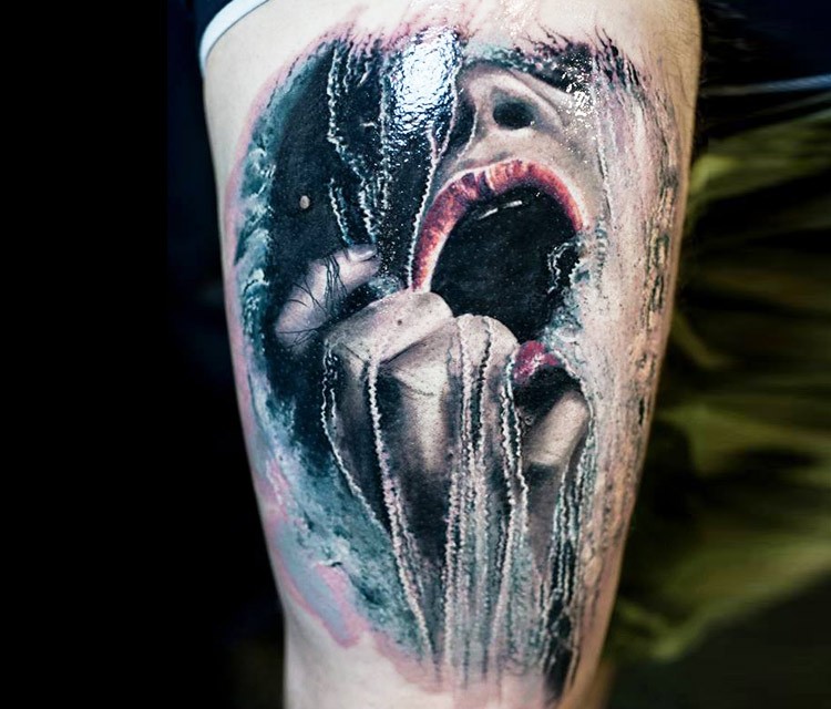 Creative painted horror style upper arm tattoo of screaming frozen woman