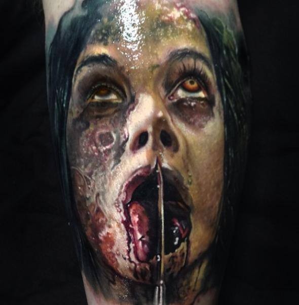 Creepy modern looking leg tattoo of zombie monster face
