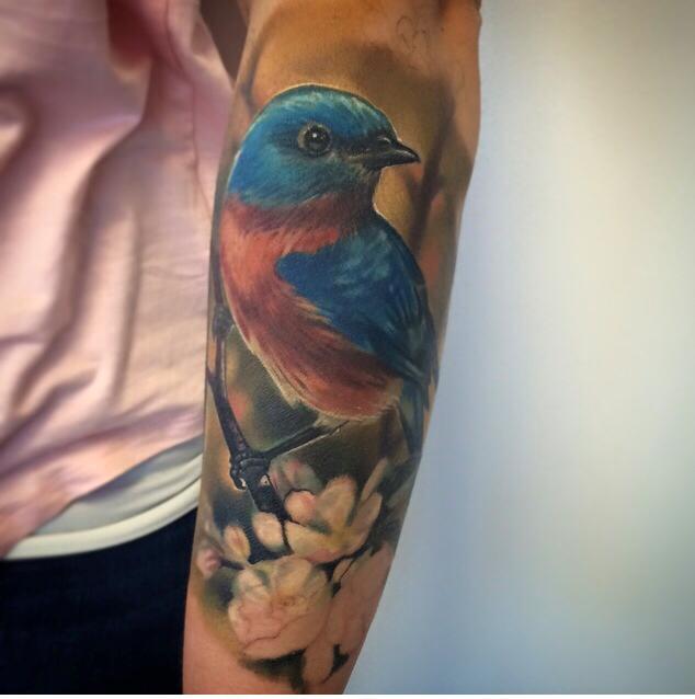 Cute bird tattoo on forearm
