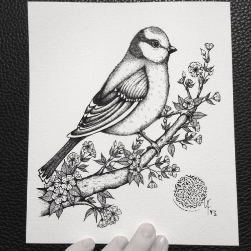Cute black-and-white bird sitting on blossom branch tattoo design