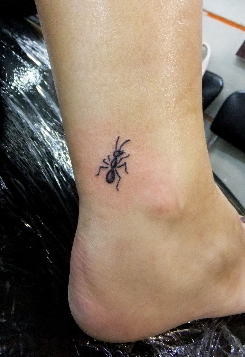 Cute black-ink ant tattoo for girls on foot
