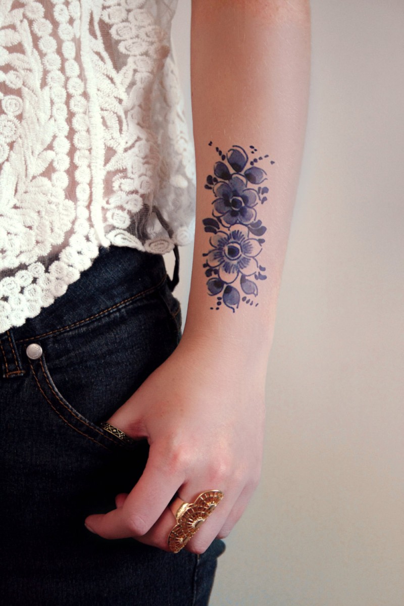 Cute blue vintage flowers tattoo on arm