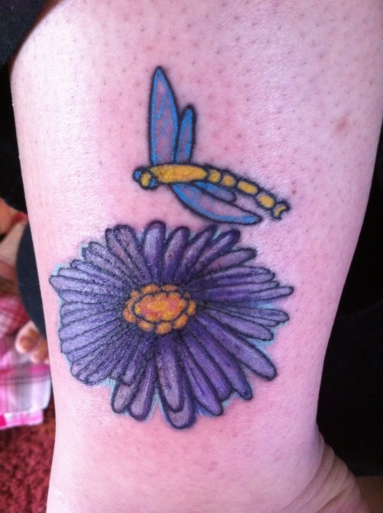 Cute cartoon violet aster flower with bee tattoo on shin