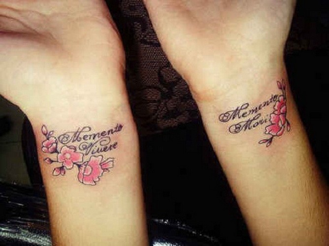 Cute double latin quote tattoos with pink flowers on arms