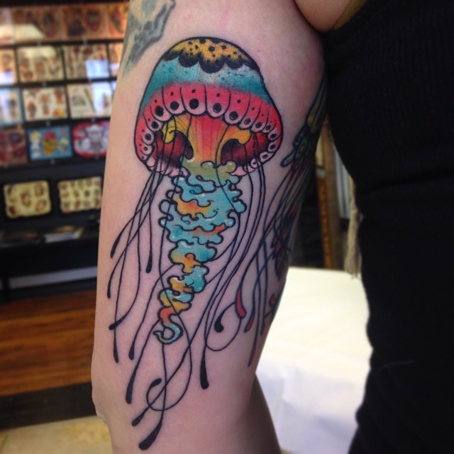 Cute girly colored jellyfish tattoo on arm
