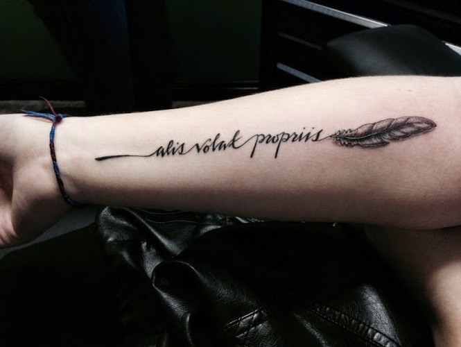 Cute little feather with quote tattoo on arm