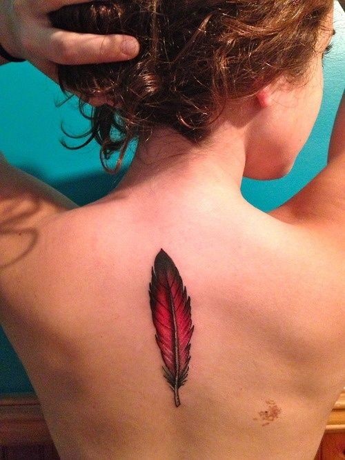 Cute red feather tattoo on back