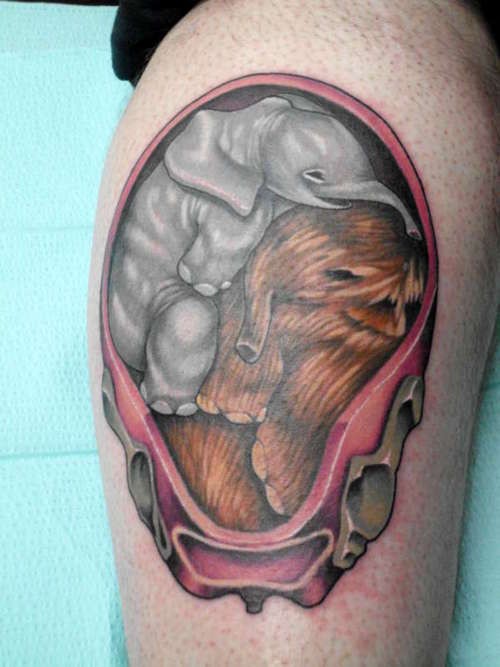 Cute unborn colorful mammoth and elephant tattoo on thigh