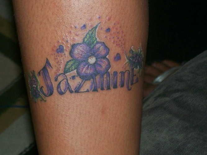 Cute violet jasmine flower with quote tattoo on shin