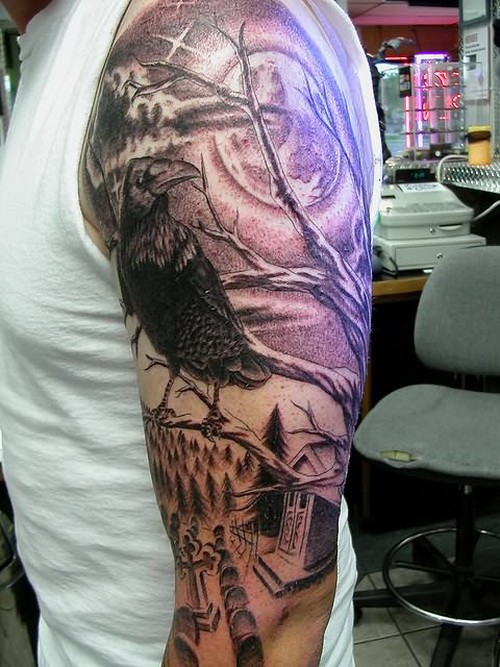 Dark gloomy raven in graveyard tattoo on upper arm