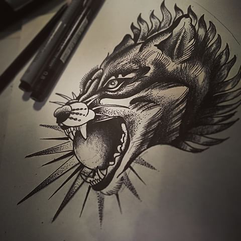 Devilish grey wolf keeping a shining ball in the mouth tattoo design