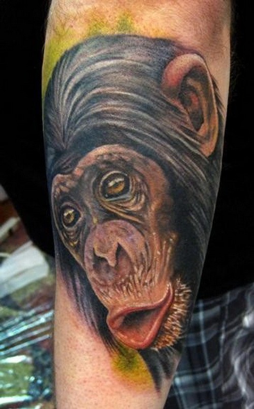 Exiting color-ink chimpanzee head tattoo on arm