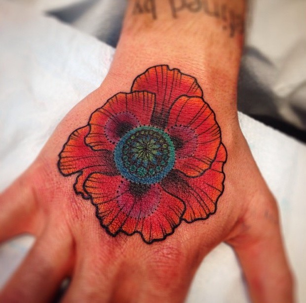 Exiting poppy flower tattoo on hand