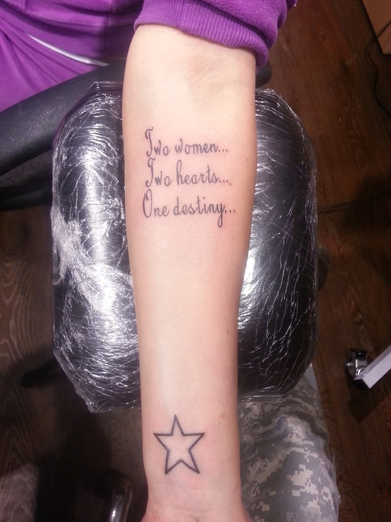 Friendly quote with clear star tattoo on arm