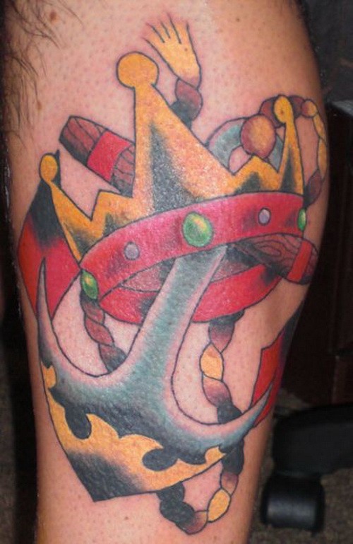 Funny colored old school anchor with golden crown on tattoo on shin