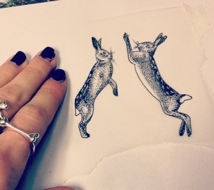 Funny dotwork-style jumping hares tattoo design