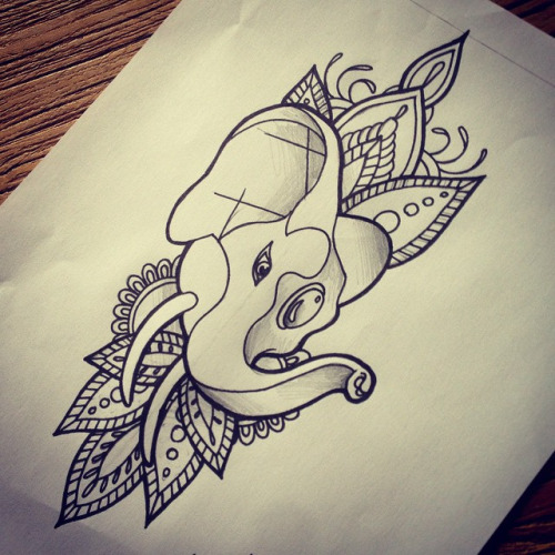 Gem-decorated elephant head on indian-patterned background tattoo design