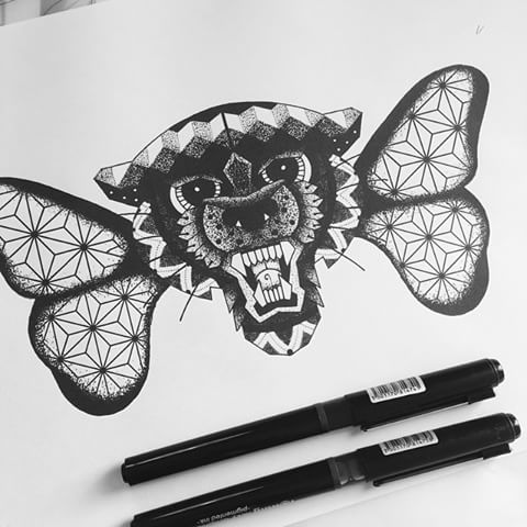 Gnarling animal muzzle with geometric butterfly wings tattoo design