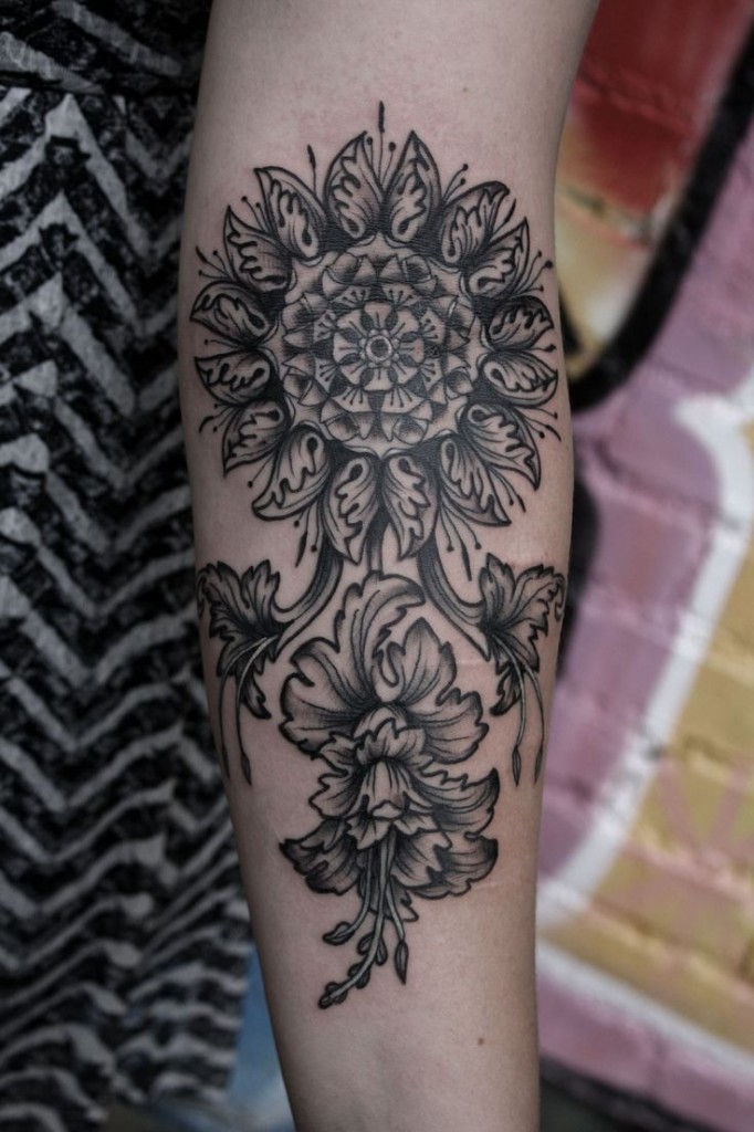 Gorgeous mandala flower on stem tattoo on arm