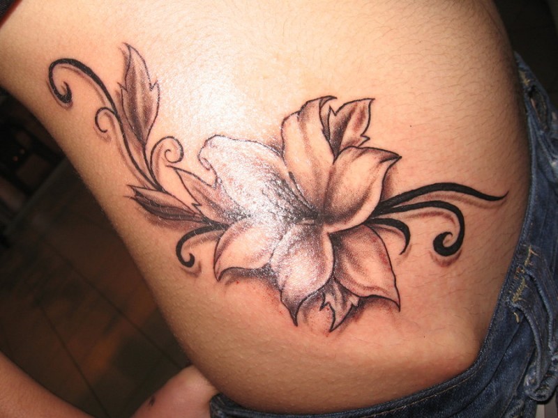 Great black-ink jasmine flower tattoo on side