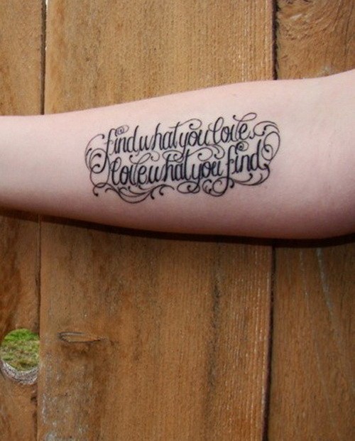 Great black-lettered quote tattoo with a lot of curls on arm